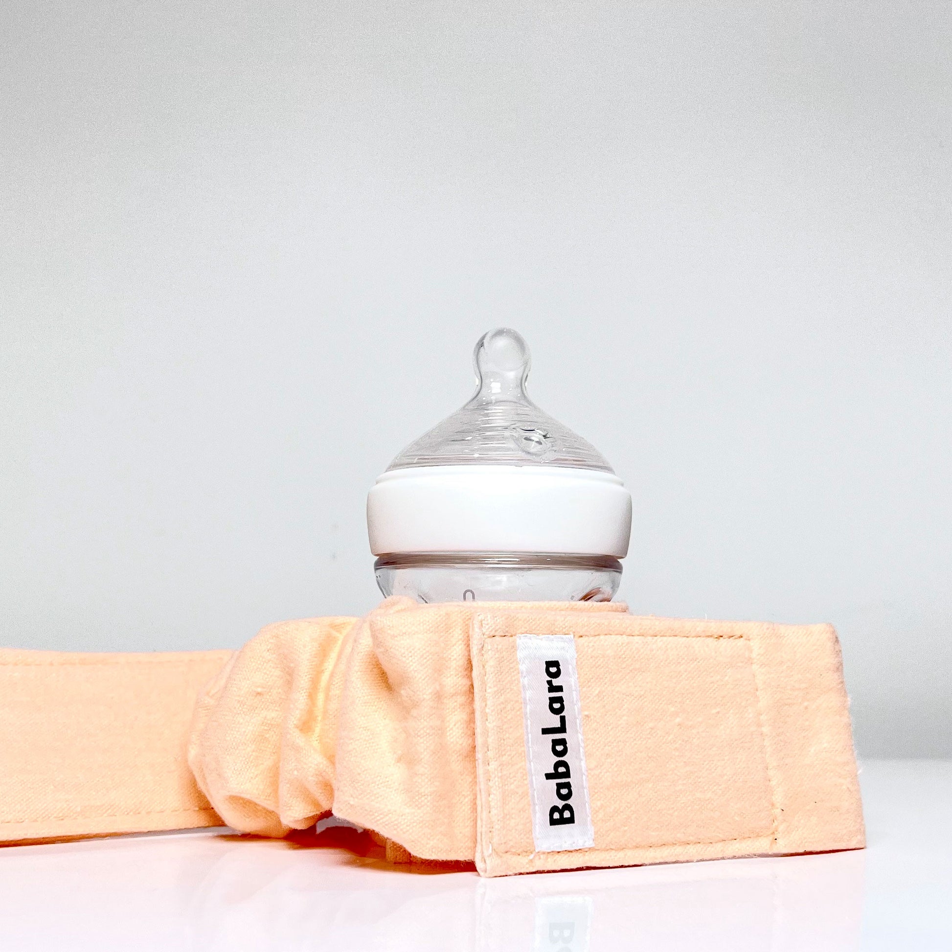 belt accessory holds tightly to sippy cups and baby bottles 